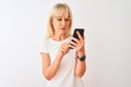 Middle age woman using smartphone standing over isolated white background with a confident expression on smart face thinking Royalty Free Stock Photo