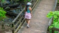 Middle Age woman walking wooden bridge on trail in National Park Royalty Free Stock Photo