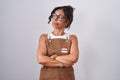 Middle age woman wearing apron over white background looking to the side with arms crossed convinced and confident Royalty Free Stock Photo