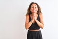 Middle age woman wearing black casual dress standing over isolated white background praying with hands together asking for Royalty Free Stock Photo