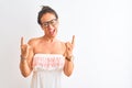 Middle age woman wearing casual dress and glasses standing over isolated white background shouting with crazy expression doing Royalty Free Stock Photo