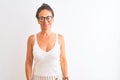 Middle age woman wearing casual t-shirt and glasses standing over isolated white background with a happy and cool smile on face Royalty Free Stock Photo