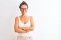 Middle age woman wearing casual t-shirt and glasses standing over isolated white background happy face smiling with crossed arms Royalty Free Stock Photo