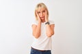 Middle age woman wearing casual t-shirt standing over  white background Tired hands covering face, depression and sadness, Royalty Free Stock Photo