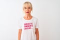 Middle age woman wearing fanny t-shirt with irony comments over isolated white background with a confident expression on smart