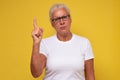 Middle age woman wearing in glasses pointing with finger up having serious expression Royalty Free Stock Photo