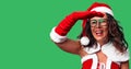 Middle age woman wearing Santa Claus costume very happy and smiling looking far away with hand over head Royalty Free Stock Photo