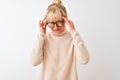 Middle age woman wearing turtleneck sweater and glasses over isolated white background with hand on head for pain in head because Royalty Free Stock Photo