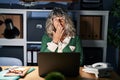 Middle age woman working at night using computer laptop bored yawning tired covering mouth with hand Royalty Free Stock Photo