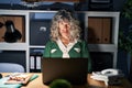 Middle age woman working at night using computer laptop depressed and worry for distress, crying angry and afraid Royalty Free Stock Photo