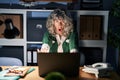 Middle age woman working at night using computer laptop doing stop gesture with hands palms, angry and frustration expression Royalty Free Stock Photo