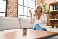 Middle age woman worried talking on the smartphone at home Royalty Free Stock Photo