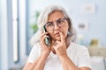 Middle age woman worried talking on the smartphone at home Royalty Free Stock Photo