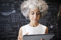 Middle aged academic woman using tablet, close up Royalty Free Stock Photo