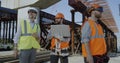 Male engineers discussing plan on construction site Royalty Free Stock Photo