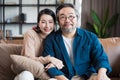 Middle-aged Asian couple smiling for the camera. Family couple portrait. Royalty Free Stock Photo