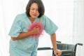 Middle aged asian lady with heart attack. Chubby woman grabbing at her breast have a heart attack and need emergency help