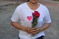 Middle aged asian woman is holding a beautiful bouquet of red roses. Love and romance Valentine`s day concept. Royalty Free Stock Photo