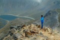 A middle aged backpacker looking over the Quilotoa volcanic crater lagoon