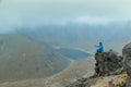 A middle aged backpacker looking over the Quilotoa volcanic crater lagoon