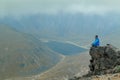 A middle aged backpacker looking over the Quilotoa volcanic crater lagoon