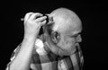 Middle aged bald man hair clipper, Mature baldness and hair loss concept. Royalty Free Stock Photo