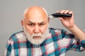 Middle aged bald man hair clipper, Mature baldness and hair loss concept. Royalty Free Stock Photo