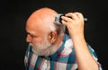 Middle aged bald man hair clipper, Mature baldness and hair loss concept. Royalty Free Stock Photo