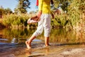 Middle-aged woman walking on river bank on autumn day. Senior lady having fun in the forest enjoying nature. Closeup Royalty Free Stock Photo