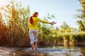 Middle-aged woman walking on river bank on spring day. Senior lady having fun in the forest enjoying nature. Royalty Free Stock Photo