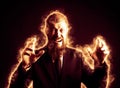 Middle-aged, bearded businessman in a rage, angry, burning in fire, boss in a flame