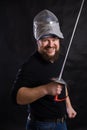 Middle aged bearded man with epee and helmet