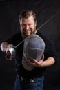 Middle aged bearded man with epee and helmet