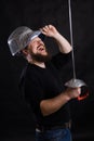 Middle aged bearded man with epee and helmet