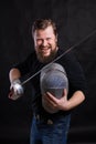 Middle aged bearded man with epee and helmet