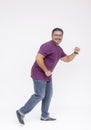 A middle aged bearded man looking at the camera while walking to the right in a comical fashion. Wearing a purple waffle shirt and Royalty Free Stock Photo