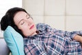 Middle aged beautiful woman lying in sofa sleeping at home after hard working day tired. Sweet dreams, good morning, new day Royalty Free Stock Photo