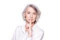 Middle aged beautiful woman putting her finger to her lips with a frown and stern look asking for quiet, isolated on Royalty Free Stock Photo