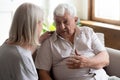 Geriatric nurse listens elderly man showing care and support