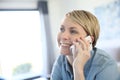 Middle-aged blond woman talking on the phone Royalty Free Stock Photo
