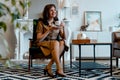 Middle Aged Brunette Woman Drinking Tea In Drawing Room And Enjoying Slow Breakfast And Tasty Breakfast Royalty Free Stock Photo