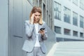 Middle aged business woman, patient has severe headache, businesswoman trying to call doctor using phone Royalty Free Stock Photo