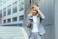 Middle aged business woman, patient has severe headache, businesswoman trying to call doctor using phone Royalty Free Stock Photo