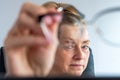 Middle-aged business woman portrait at work behind the computer monitor Royalty Free Stock Photo