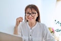 Middle aged business woman working at desk in home office, using laptop Royalty Free Stock Photo