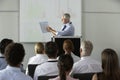 Middle Aged Businessman Delivering Presentation At Conference Royalty Free Stock Photo