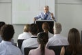 Middle Aged Businessman Delivering Presentation At Conference Royalty Free Stock Photo