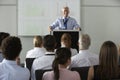 Middle Aged Businessman Delivering Presentation At Conference Royalty Free Stock Photo