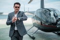 Businessman near private helicopter