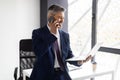 Middle Aged Businessman Talking On Cellphone And Using Laptop At Office Royalty Free Stock Photo